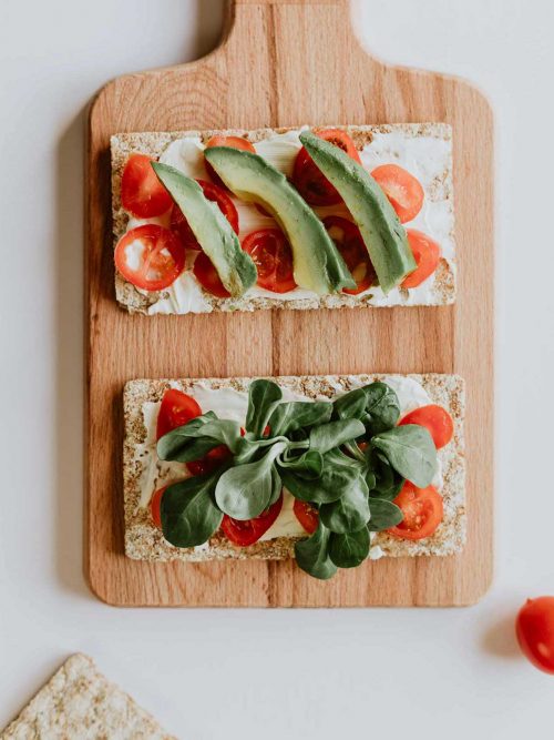 Avocado toast with fresh basil and cherry tomatos